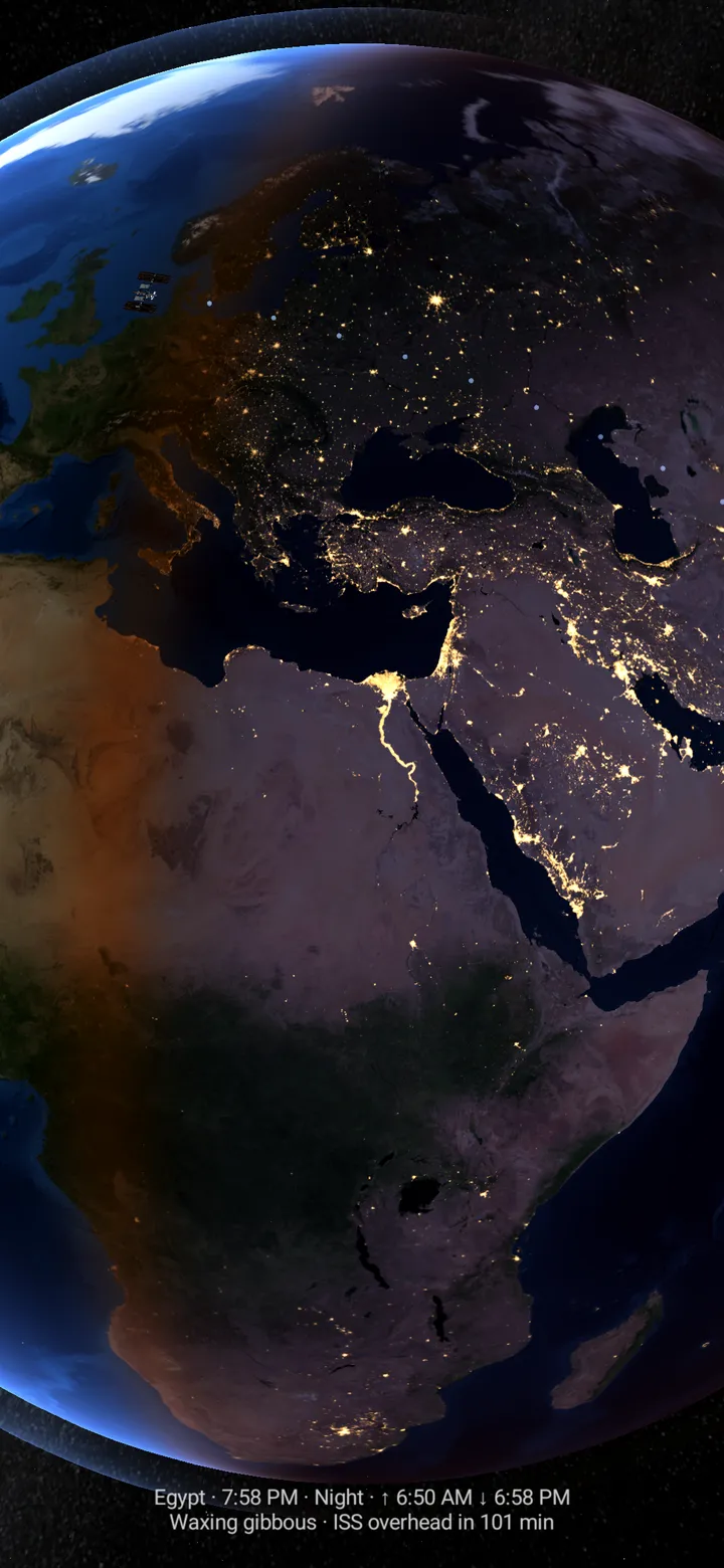 My planet in the app’s full-screen preview: Japan at dusk, city lights along the day–night line.